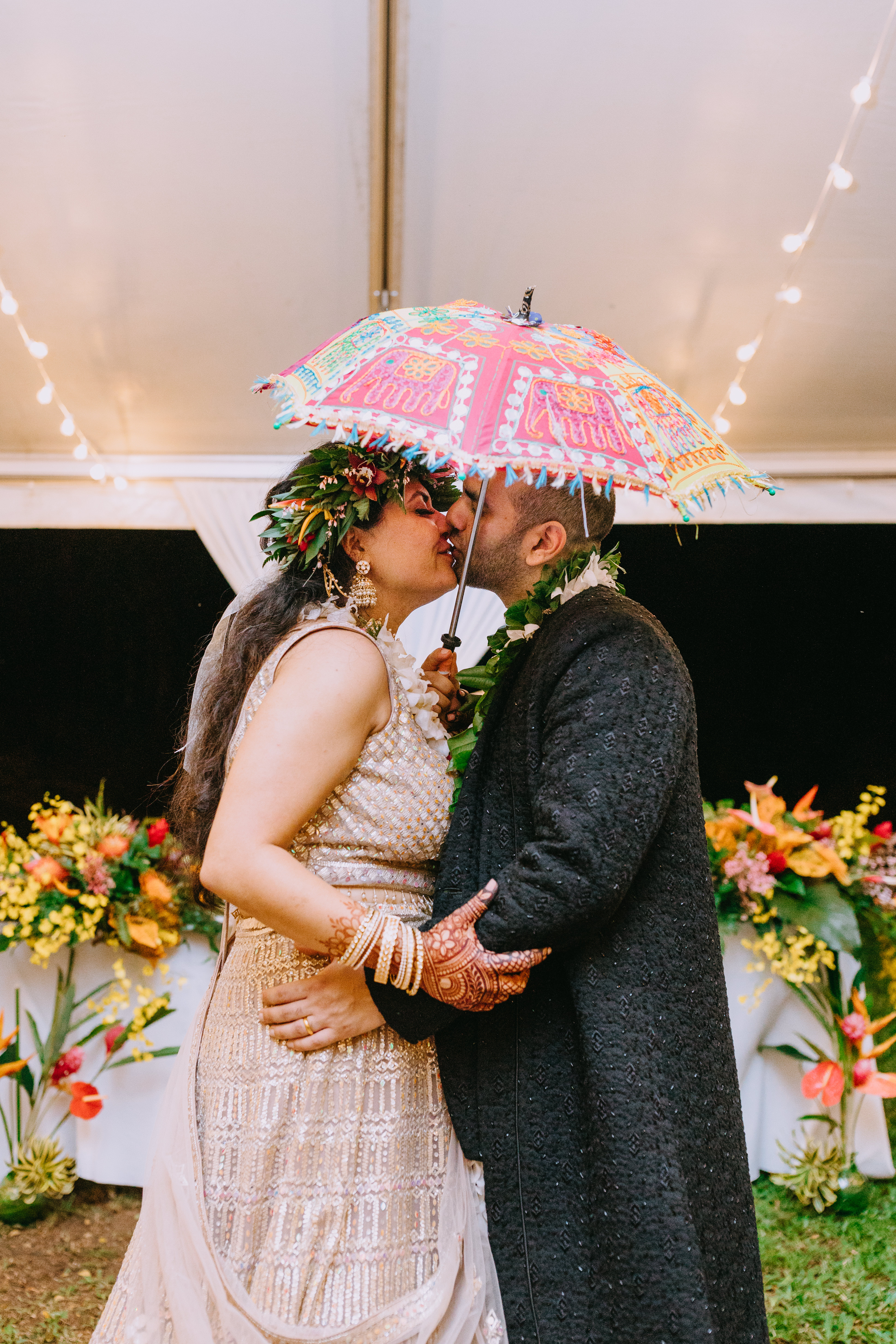 A happy wedding couple, beautifully covered in henna.